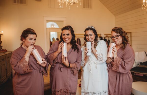 bride and her girls pose with their custom cups