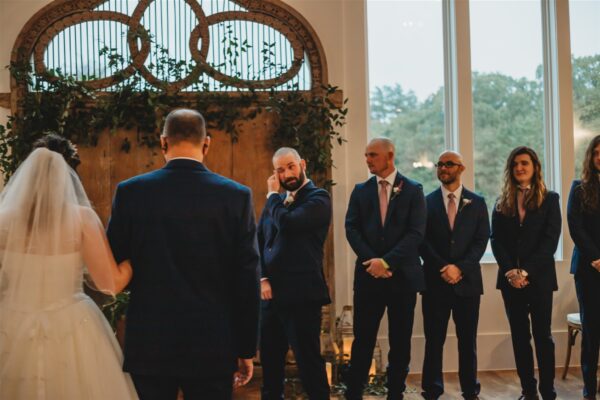 groom sheds a tear watching his spectacular bride walk down the aisle
