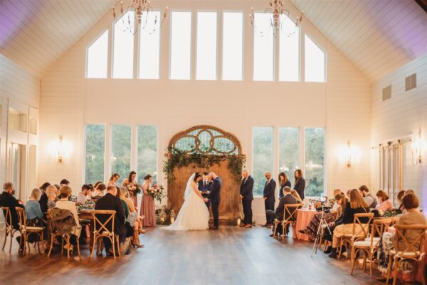 spectacular shot of bride and groom getting married at the French farmhouse venue