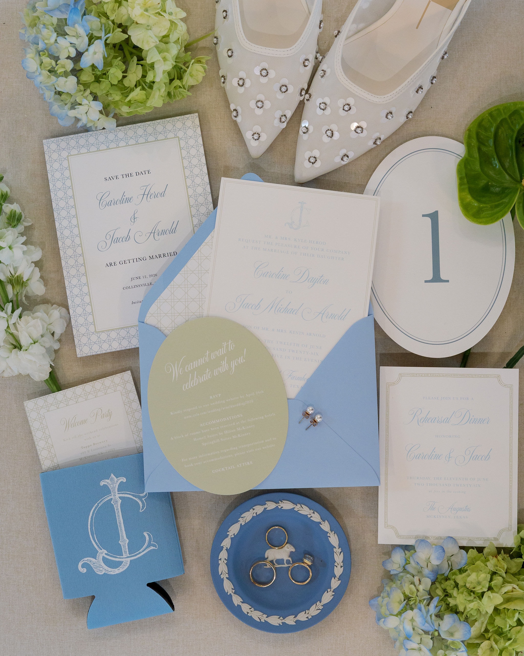 Caroline and Jacob Arnold wedding stationery flatlay with blue and cream invitations