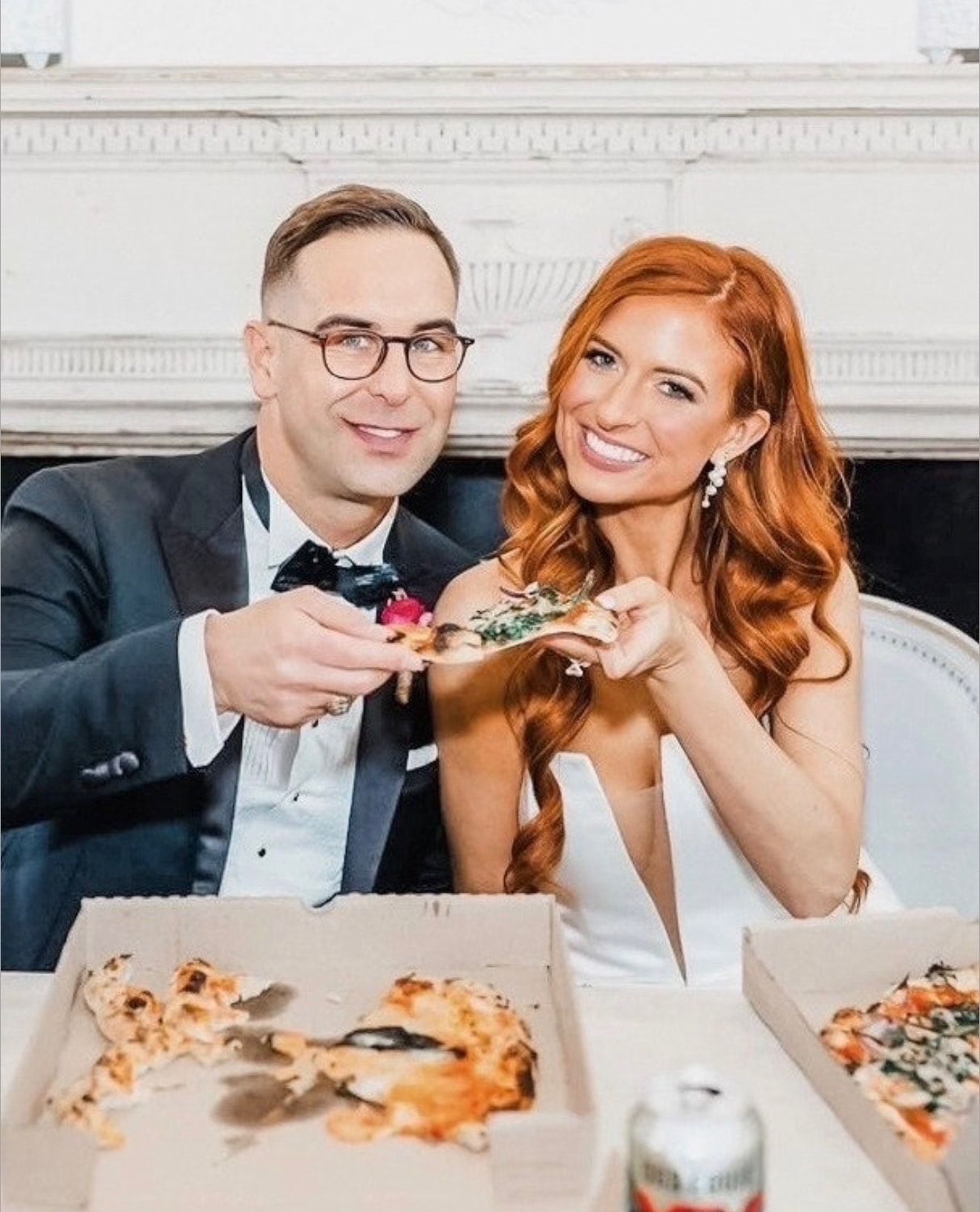 Bride and groom enjoying Fireova wood-fired pizza slices at their wedding reception