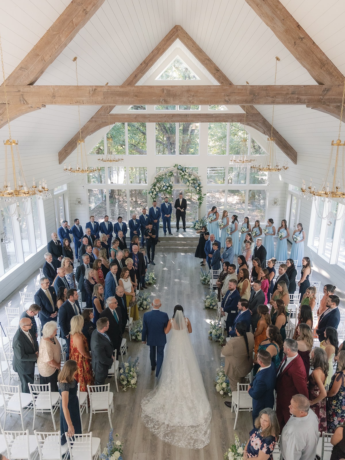 The French Farmhouse chapel exterior with steeple and manicured grounds on Corynn and CJ's wedding day