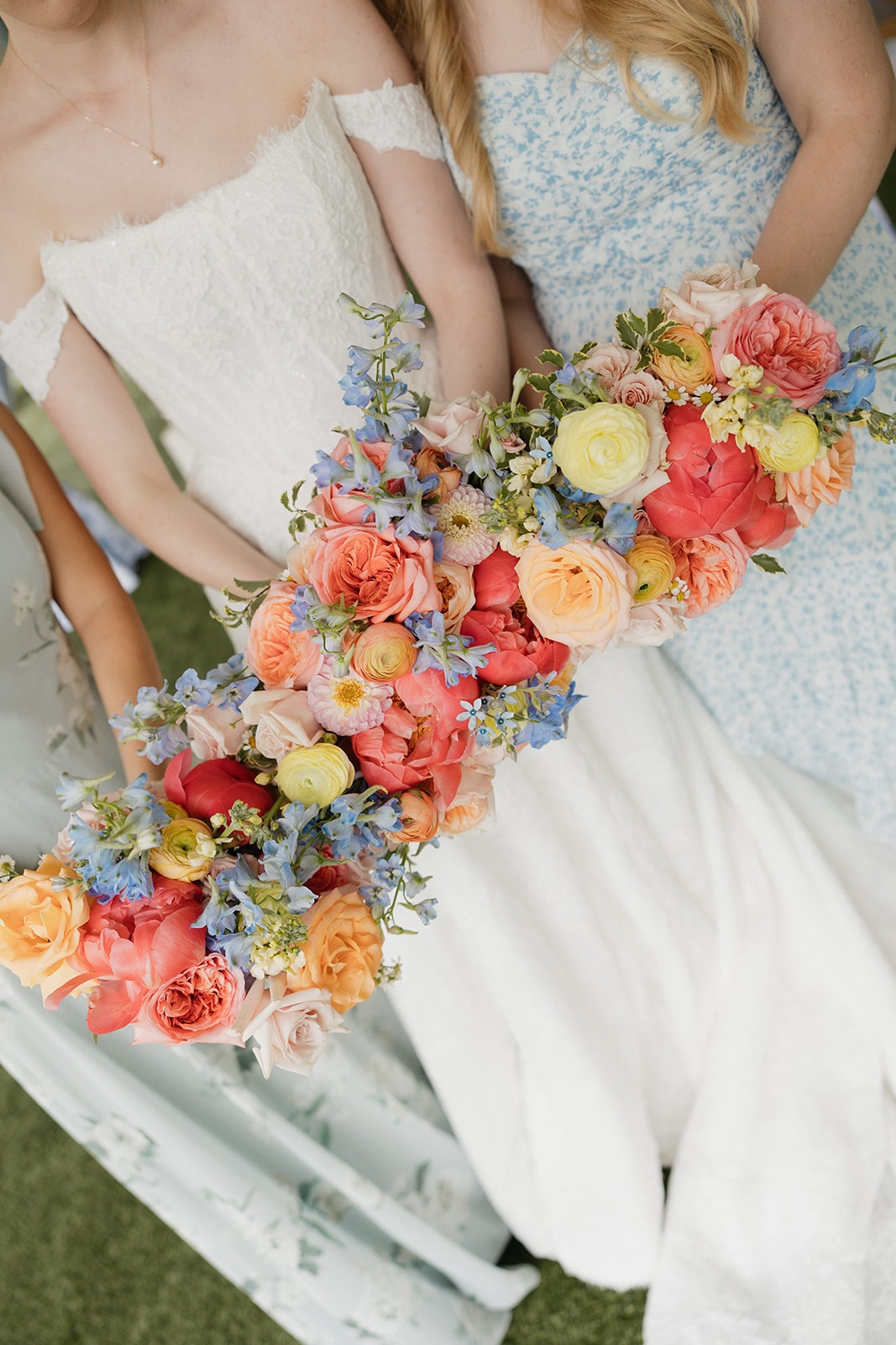 Close-up of colorful coral, peach and blue bridal bouquet