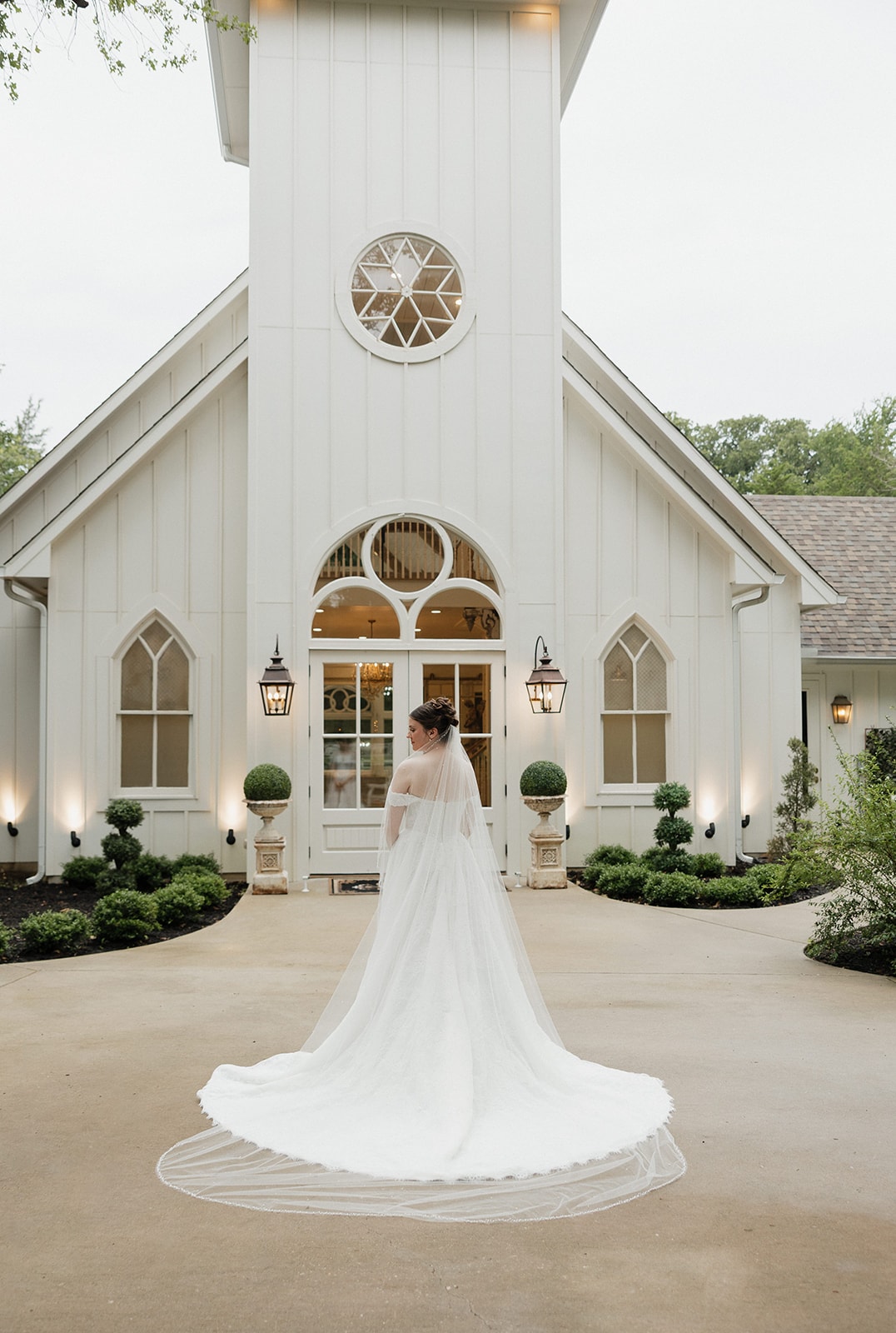 Elizabeth from behind showing her cathedral veil in front of the chapel