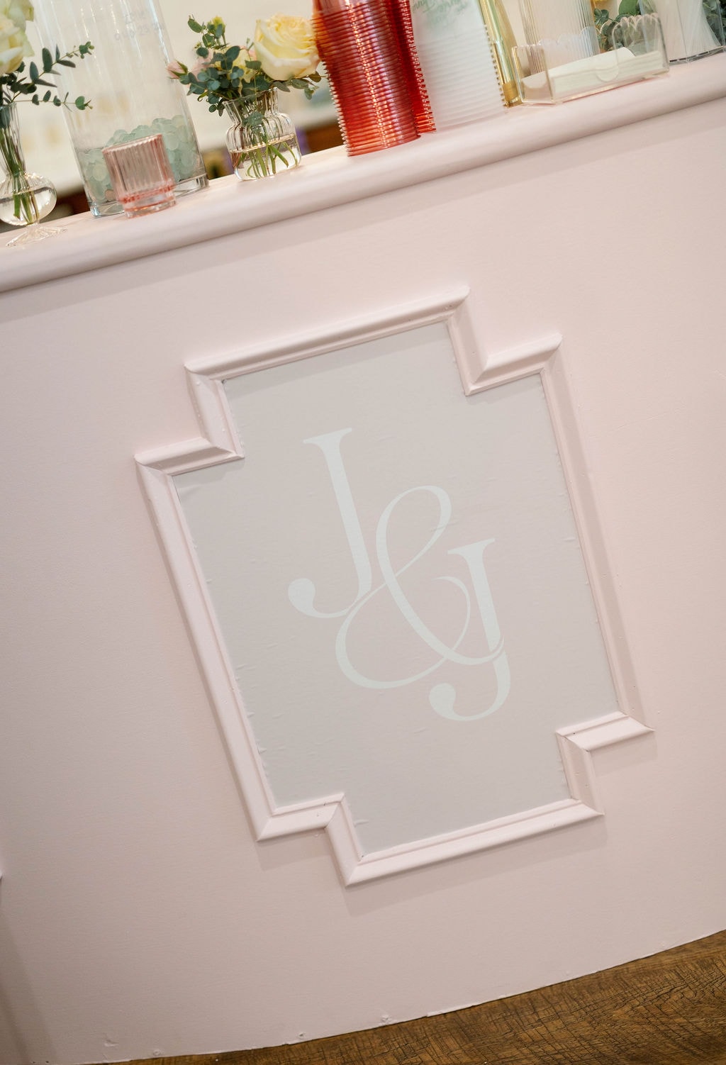 Pink bar facade with J and G monogram detail
