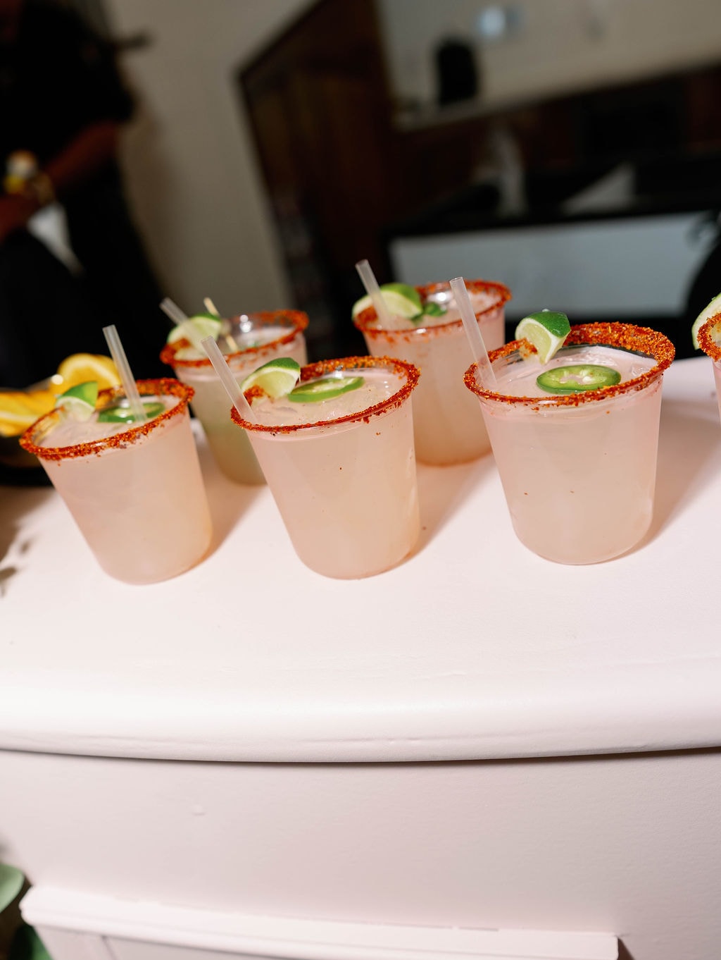 Signature spicy margaritas with tajin rims and jalapeño garnish on the bar
