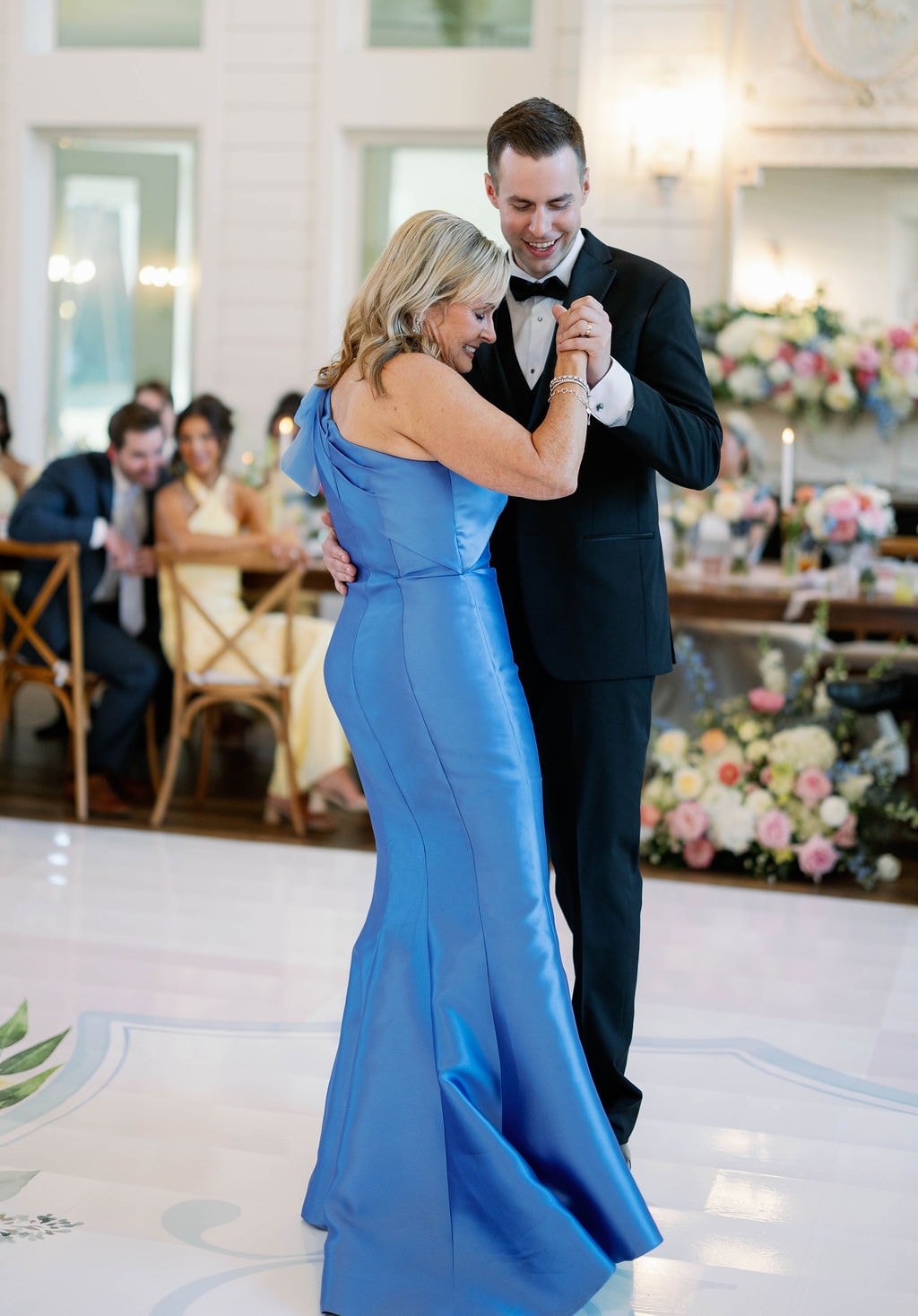Jake dancing with his mother in her blue gown during the mother-son dance at the reception
