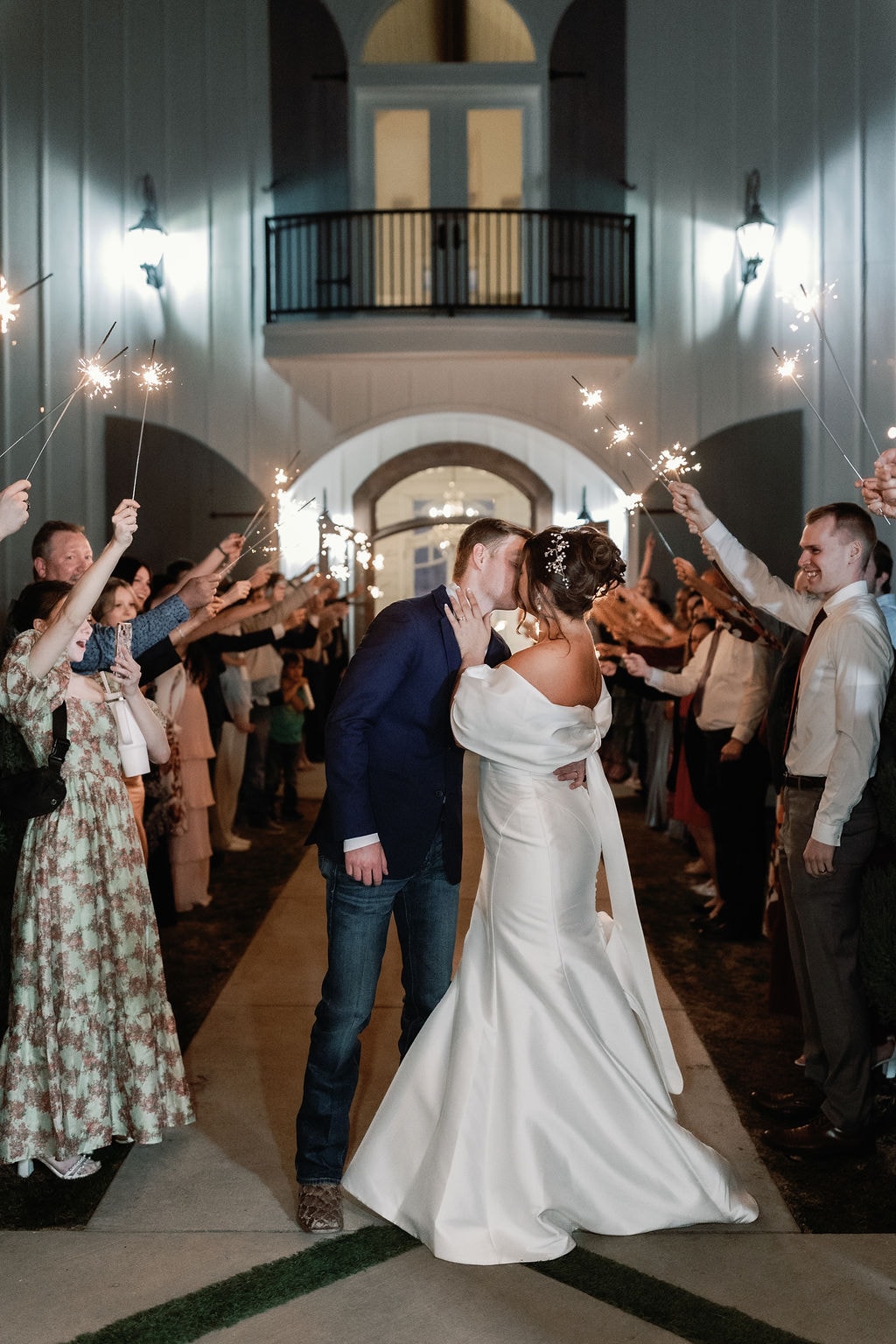 Katherine and Hayden kissing during their sparkler send-off in the venue entrance