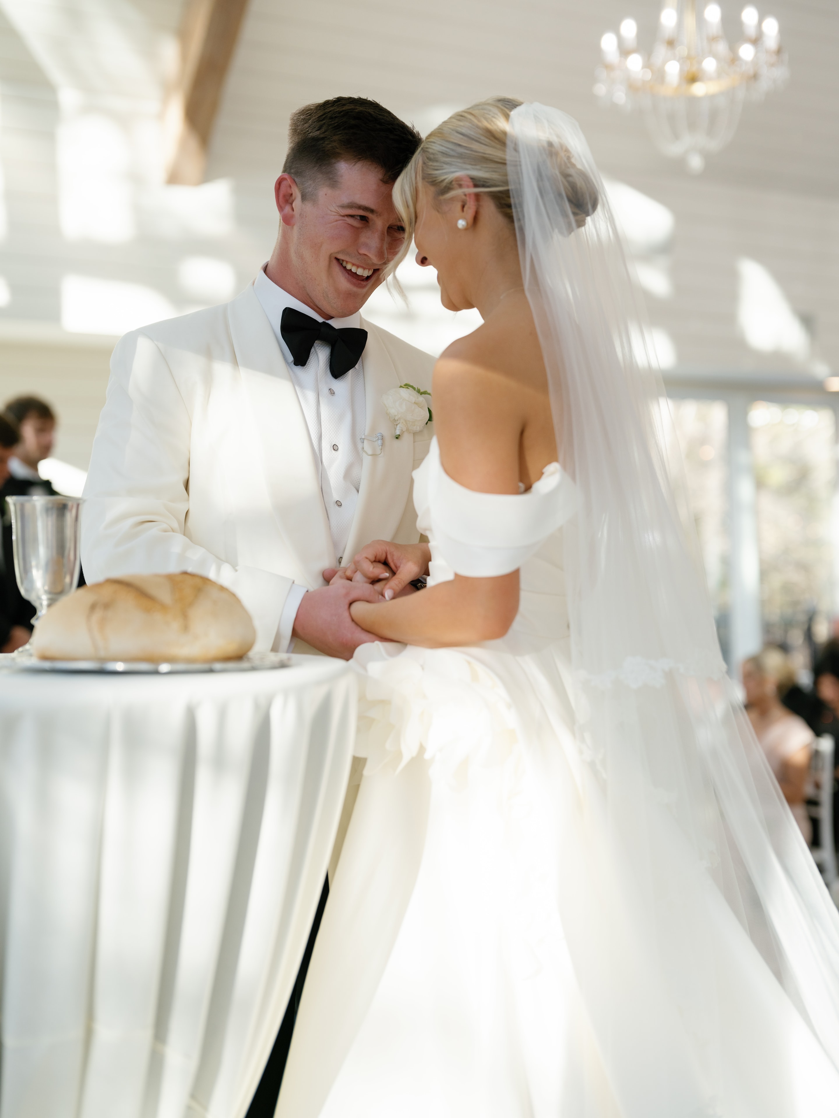Megan and Rex laughing together during their wedding ceremony vows at the altar