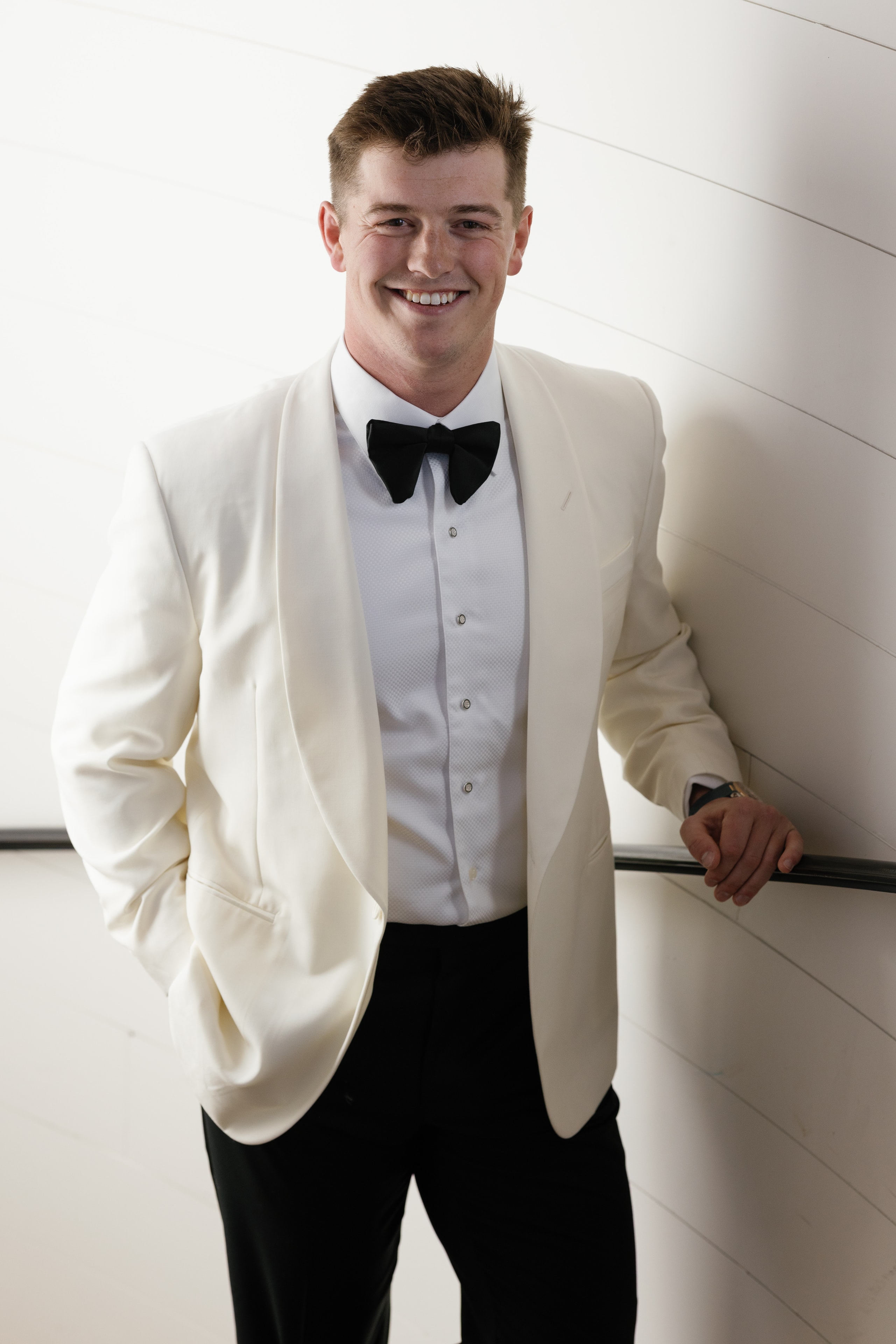 Rex Collins groom portrait in ivory tuxedo at The French Farmhouse Venue