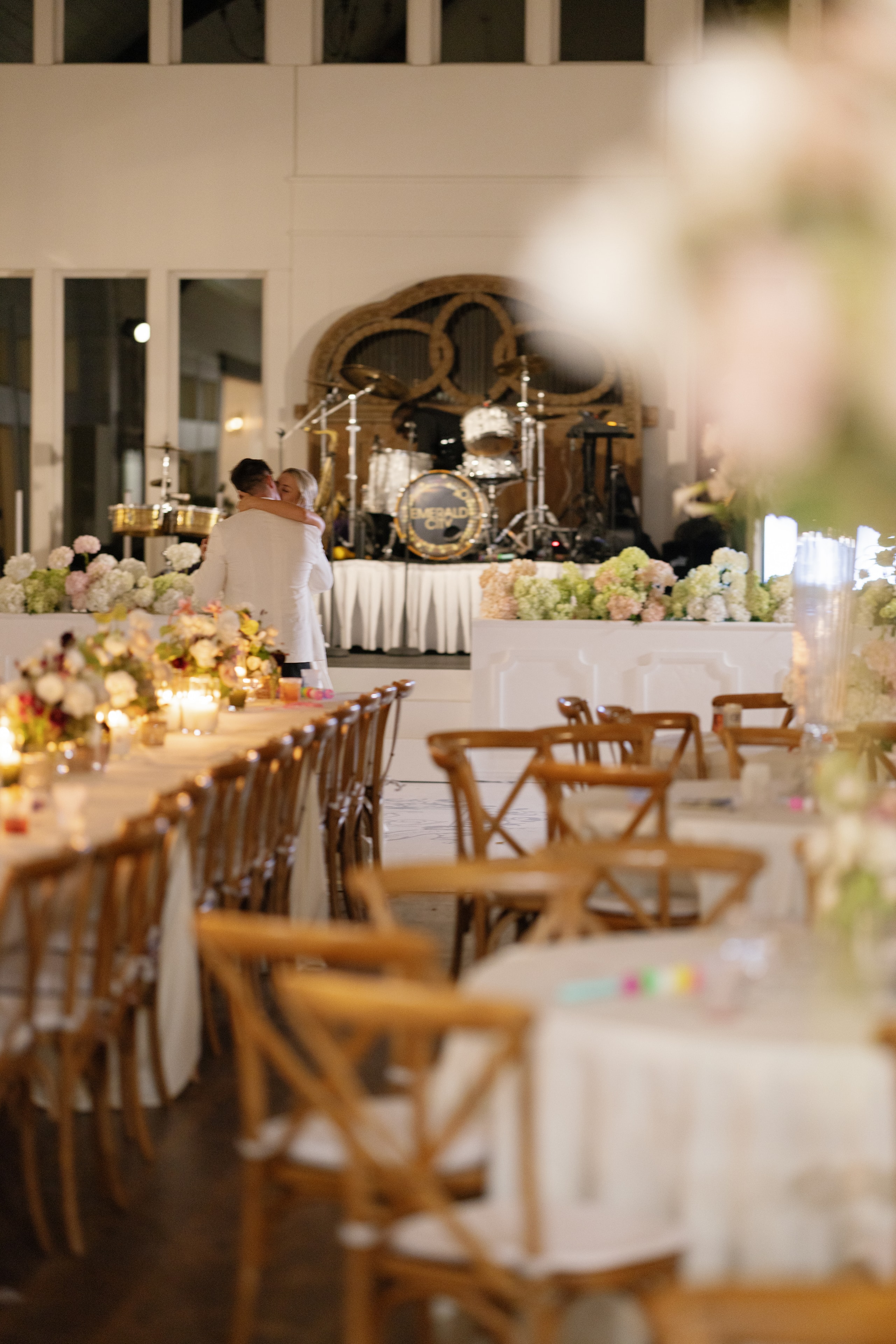 Megan and Rex sharing their first dance in front of the Emerald City Band stage at The French Farmhouse Venue