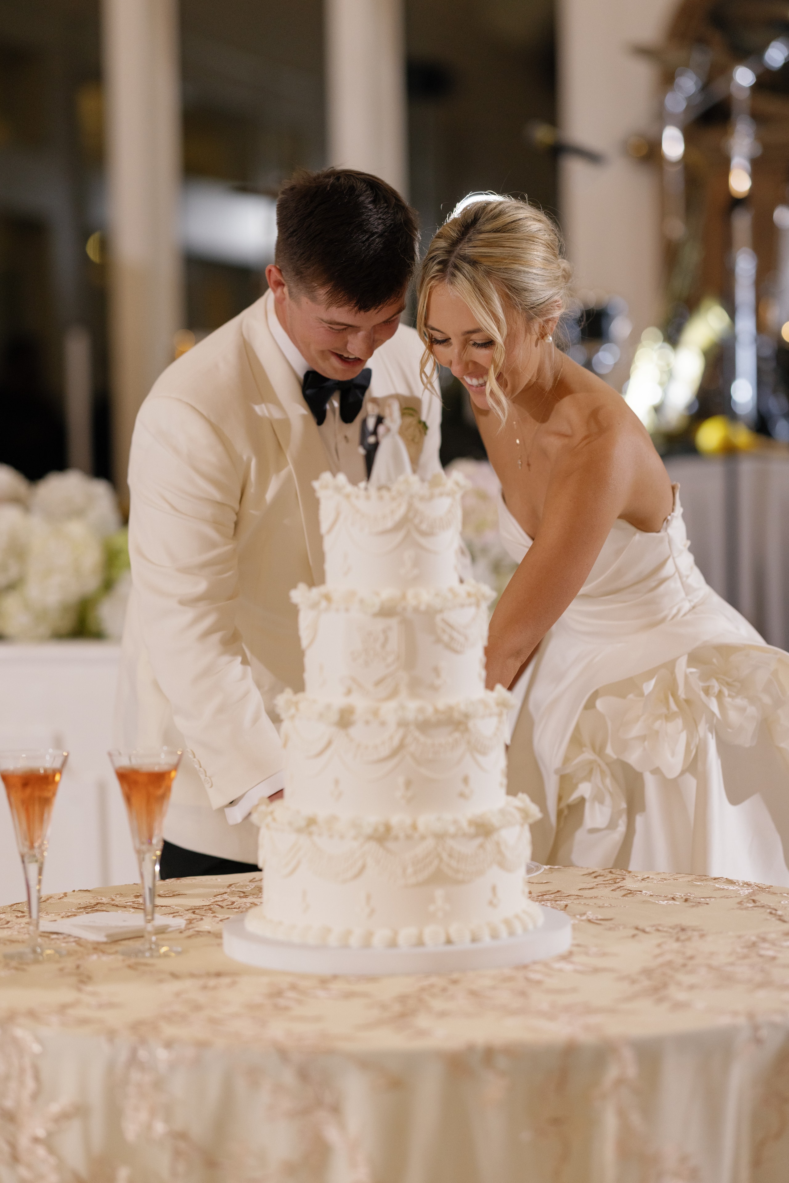 Aerial view of Megan and Rex first dance on custom monogram crest dance floor surrounded by guests