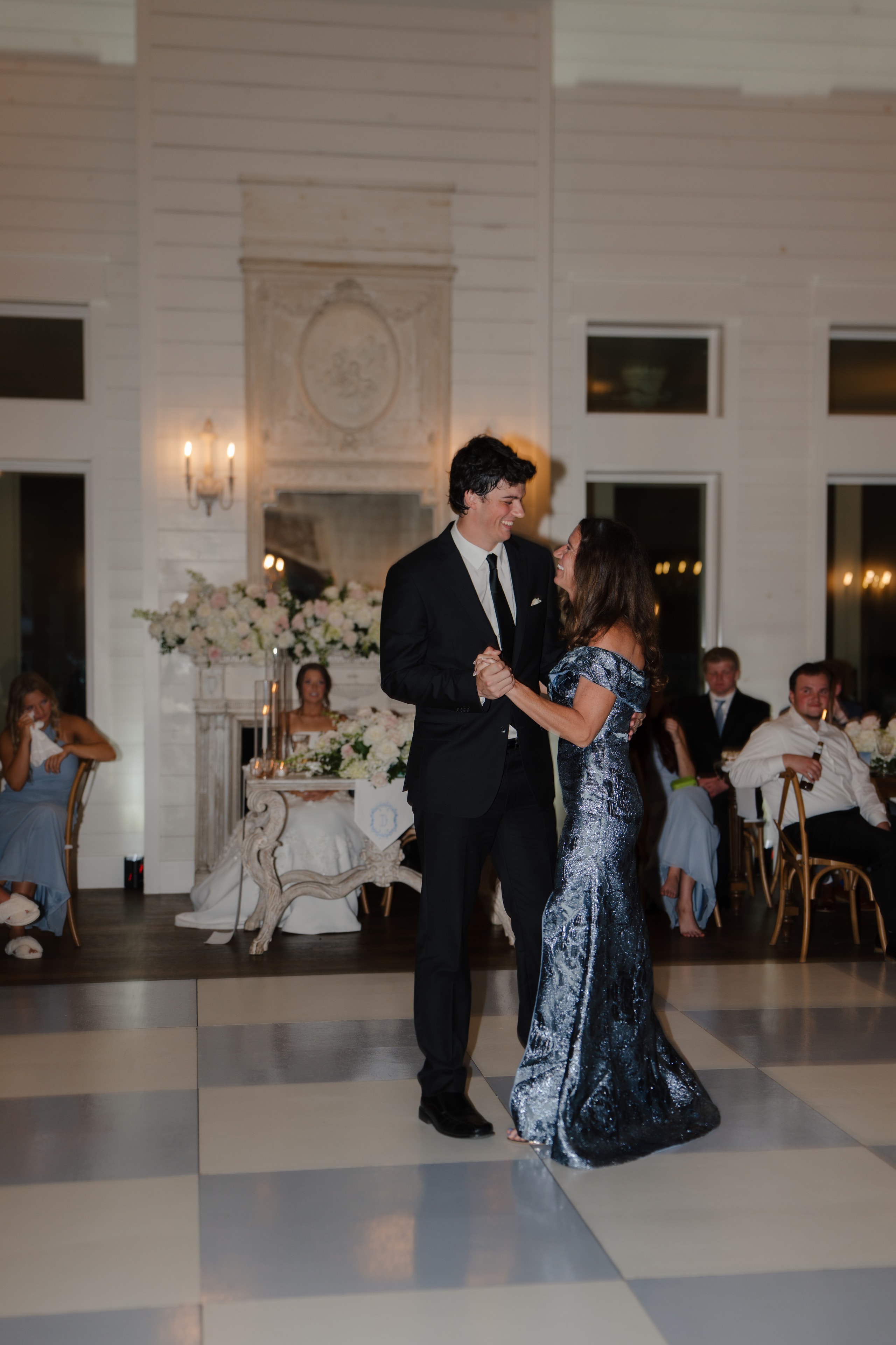 DJ dancing with his mother in her silver sequin gown during the mother-son dance at The French Farmhouse Venue reception