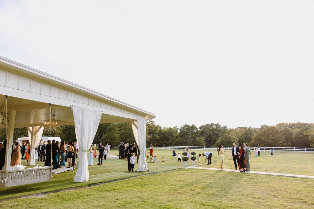 Elegant white bar setup with signature cocktail menus and floral accents on the pavilion