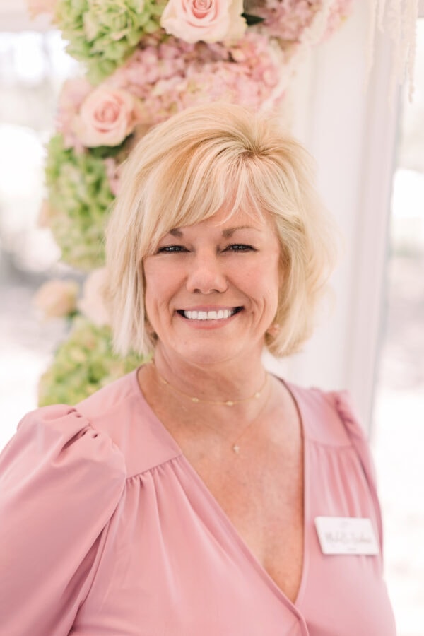 Kylee smiling while getting ready in the bridal suite at The French Farmhouse Venue