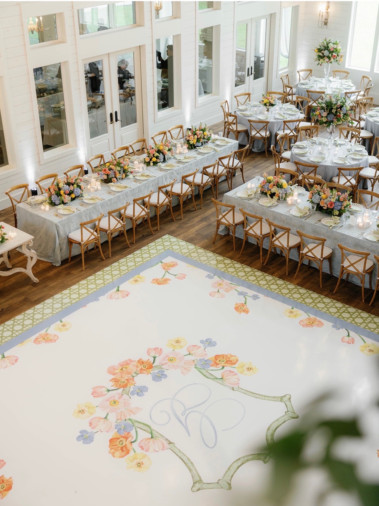 Custom monogrammed cocktail bar with floral wrap and signature drink menu at Kylee and Connor's wedding reception at The French Farmhouse Venue
