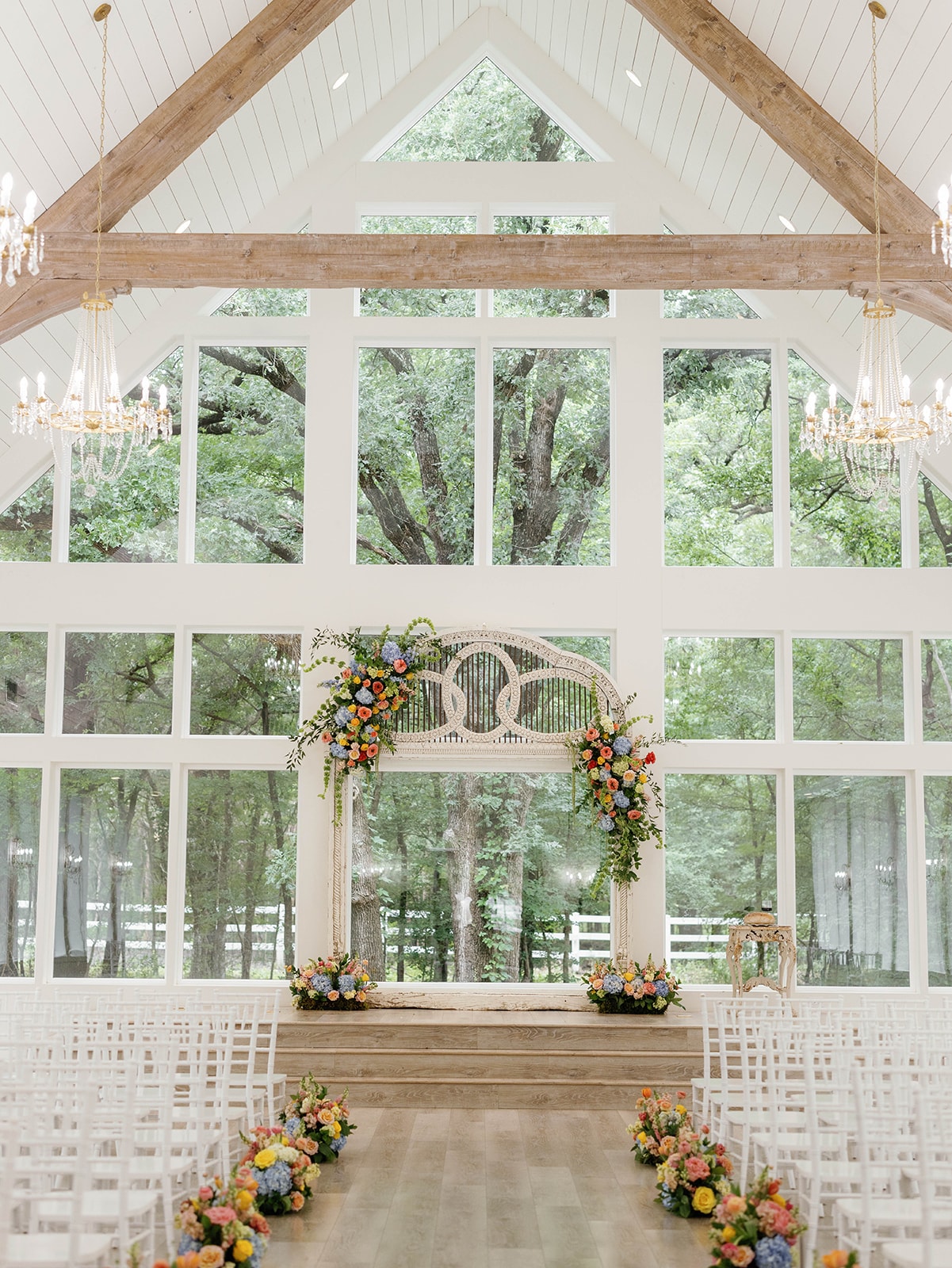 Chapel interior with colorful florals at The French Farmhouse Venue