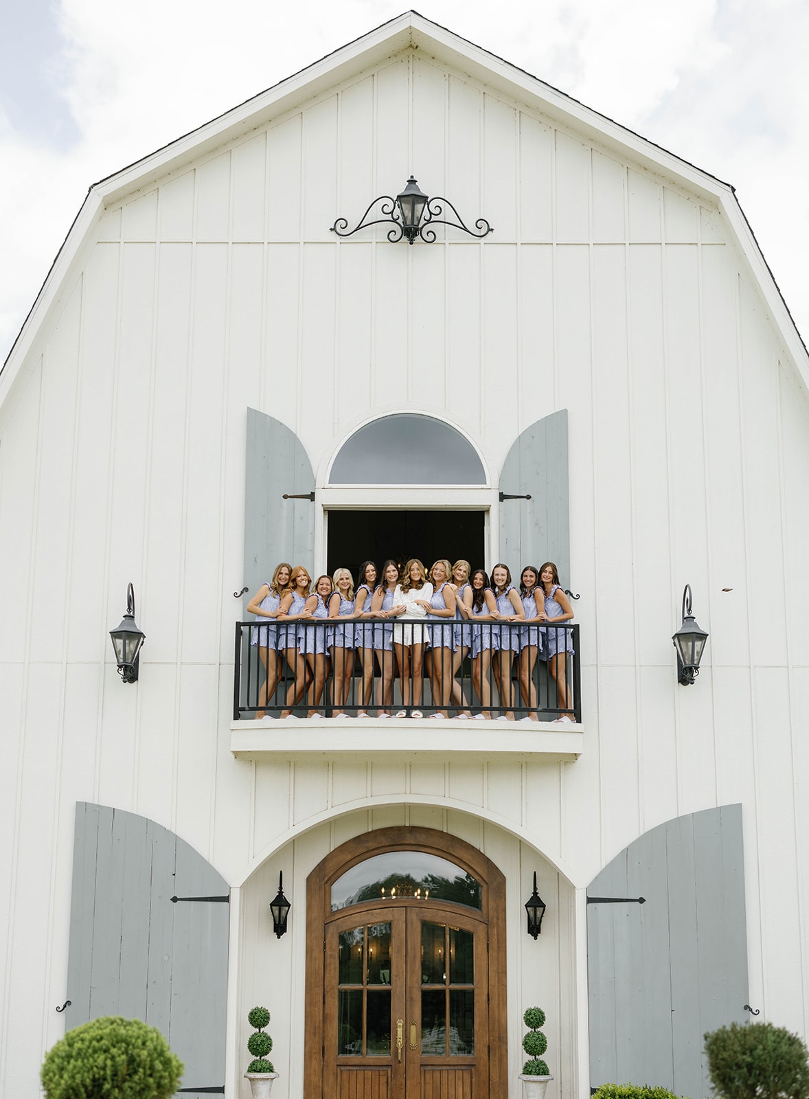 Bridesmaids and bride on the balcony of The French Farmhouse Venue