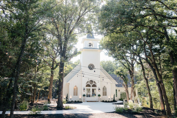 A Beautiful chapel in the woods with string lights located at the French Farmhouse Venue in Collinsville